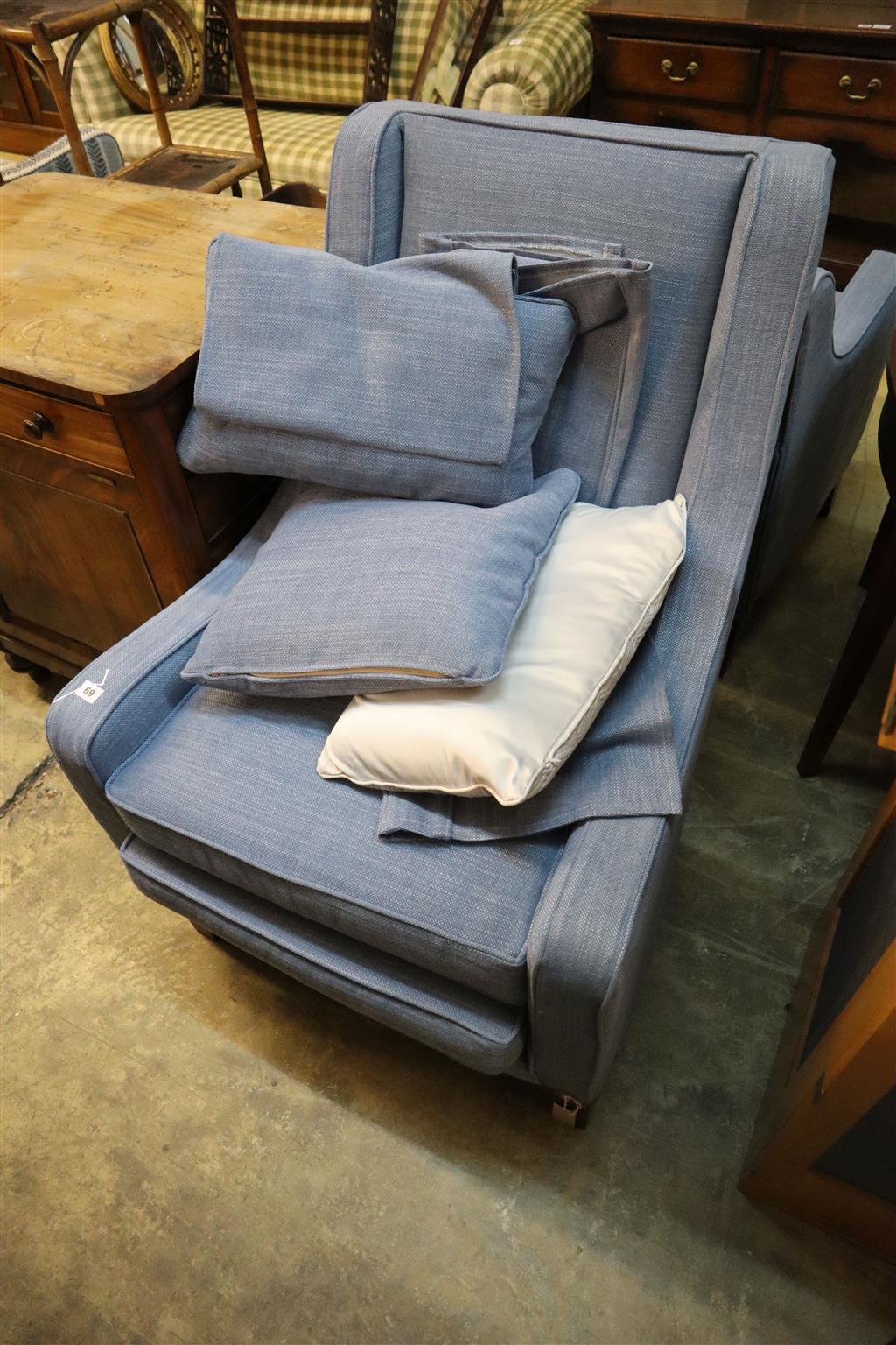 Two modern square frame armchairs with blue upholstery and a matching footstool